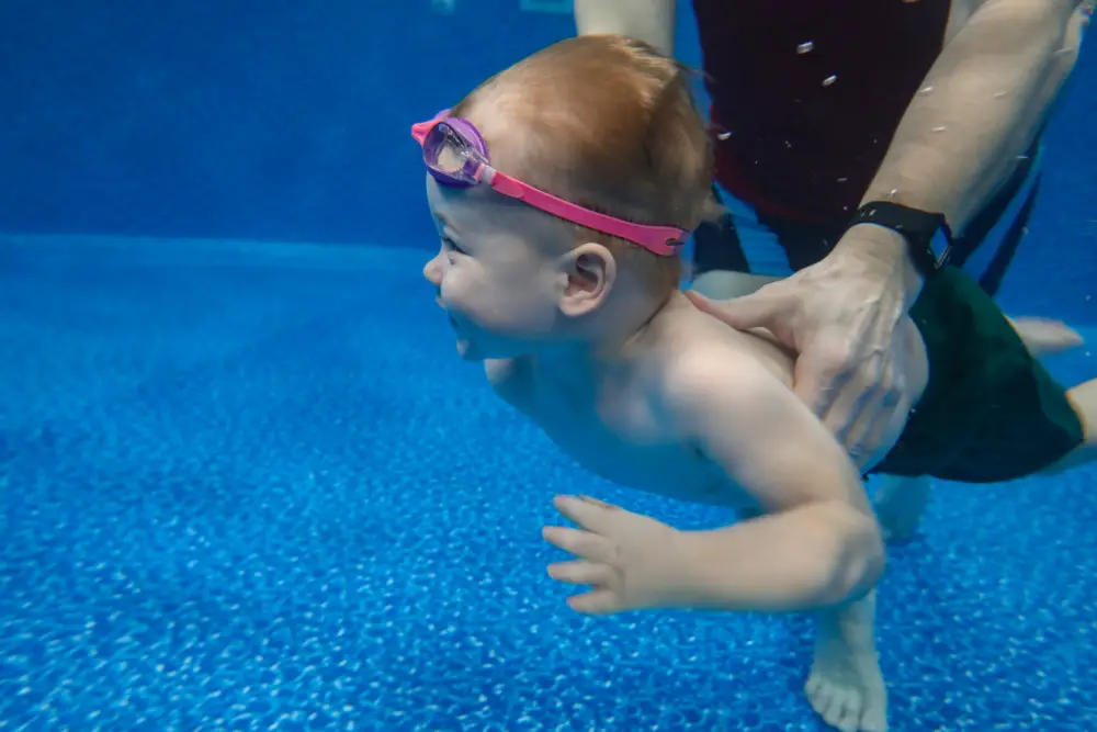 Mini Star 1_ 2 months - 8 months Baby boy dives underwater in the pool with pleasure