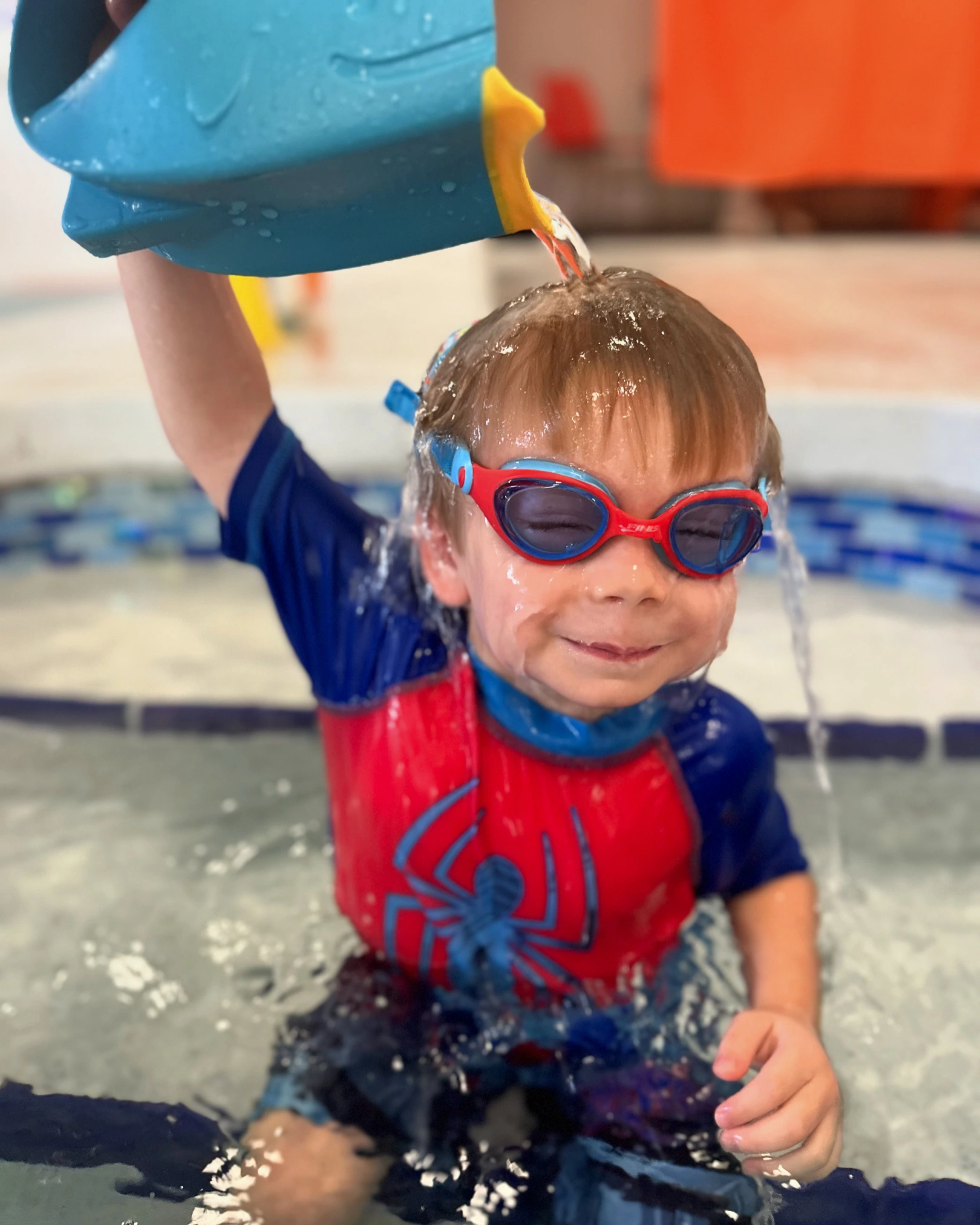 Fintastic Kid Drench happy childrens group at swimming pool class learning to swim