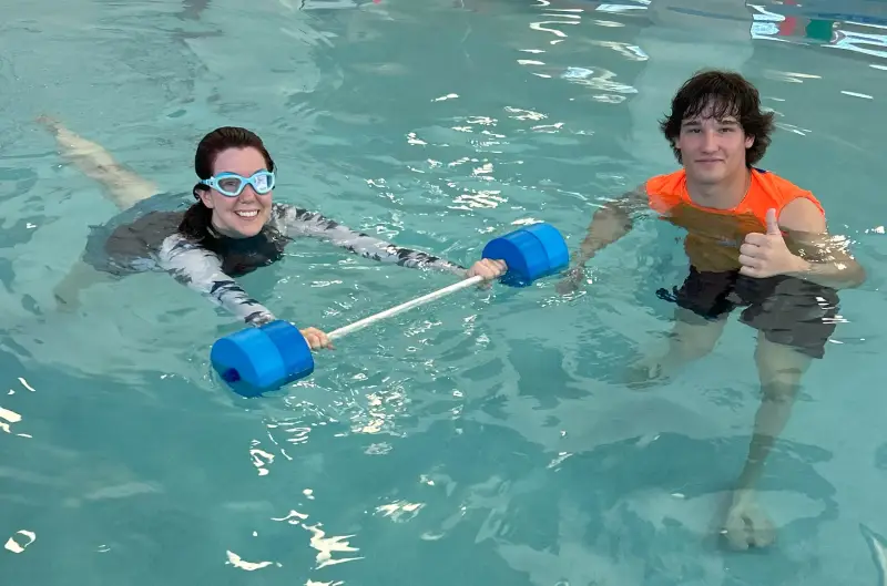 Main Page- Adults High angle view of cheerful trainers and senior swimmers in pool