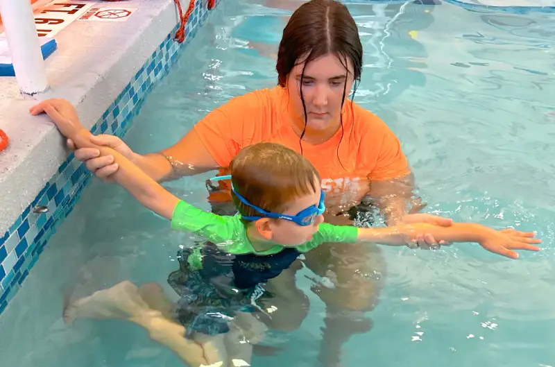 Special Needs Banner Boy on swimming class with instructor