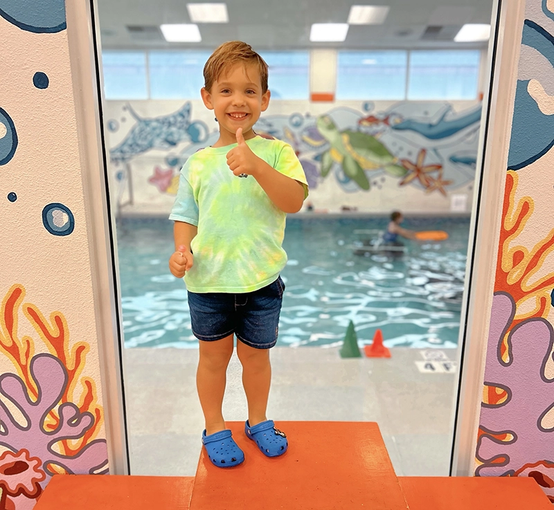 Advancing to the Next Level- Parent and Me Little tyke giving the thumbs up before his Parent and Me swim lesson
