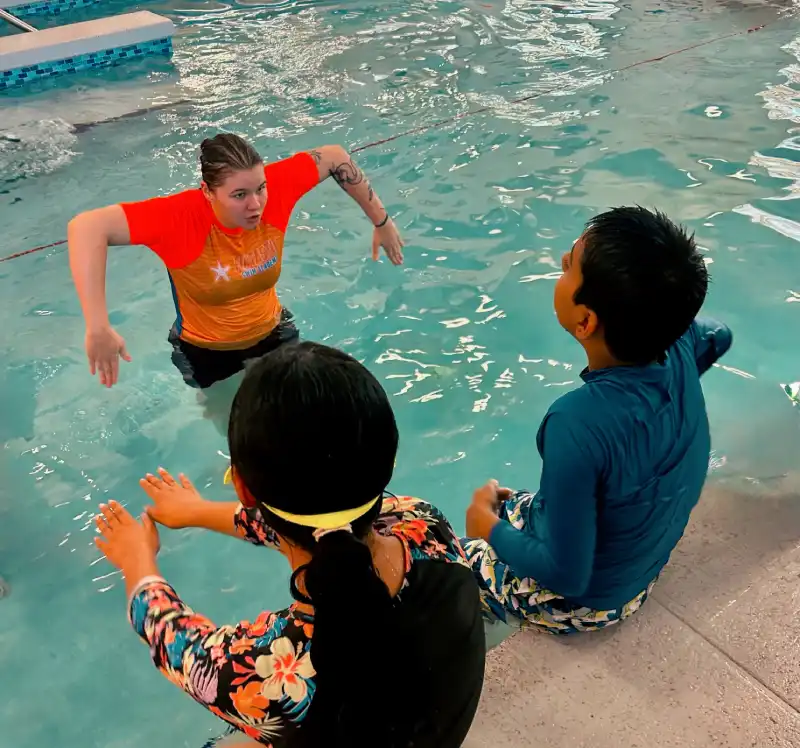 Group Levels Star 6 top view of a 7-year boy swimming backstroke in a swimming pool
