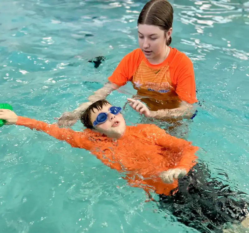 Group classes- star 5 close up photo of a 7-year boy playing and swimming in the swimming pool
